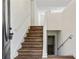 Modern staircase with wood-look flooring, leading to the upper level at 456 Pine Shadows Dr, Dallas, GA 30157