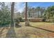 Large backyard with mature trees and level lawn at 1276 Hickory Sw Dr, Lilburn, GA 30047