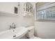 Simple bathroom with white vanity and built-in storage at 1276 Hickory Sw Dr, Lilburn, GA 30047