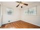 Well-lit bedroom with hardwood floors and ceiling fan at 1276 Hickory Sw Dr, Lilburn, GA 30047