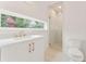 Modern bathroom with a glass shower, white vanity, and gold fixtures at 145 Arcadia Ave, Fayetteville, GA 30214