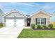 Brick and gray siding home with two-car garage and landscaped yard at 2058 Dickons Garden Ln, Mcdonough, GA 30253