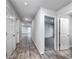 Bright hallway with wood-look flooring and doors to bedrooms at 2058 Dickons Garden Ln, Mcdonough, GA 30253