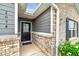 Front entrance with black door and brick and gray siding at 2058 Dickons Garden Ln, Mcdonough, GA 30253