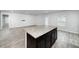 Large kitchen island with granite countertop and dark cabinets at 2058 Dickons Garden Ln, Mcdonough, GA 30253