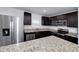 Modern kitchen with granite countertops and stainless steel appliances at 2058 Dickons Garden Ln, Mcdonough, GA 30253