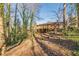 House back view with deck and wooded area at 3390 Kenland Se Rd, Smyrna, GA 30082