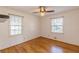 Hardwood floor bedroom with two windows and ceiling fan at 3390 Kenland Se Rd, Smyrna, GA 30082