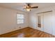 Bright bedroom with hardwood floors, ceiling fan, and mirrored closet doors at 3390 Kenland Se Rd, Smyrna, GA 30082