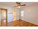 Bedroom with hardwood floors, bathroom access, and view of hallway at 3390 Kenland Se Rd, Smyrna, GA 30082