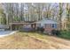 Brick ranch house with carport and mature trees at 3390 Kenland Se Rd, Smyrna, GA 30082