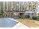 Brick ranch house with carport and mature trees at 3390 Kenland Se Rd, Smyrna, GA 30082