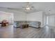 Open concept living room with gray sectional and wood flooring at 540 Saddle Shoals Dr, Lawrenceville, GA 30046