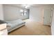 Neutral bedroom with carpet, window, and ensuite access at 1055 Grove Valley Dr, Cumming, GA 30041