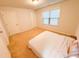 Simple bedroom with carpeted floors and large window at 1055 Grove Valley Dr, Cumming, GA 30041