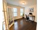 Bright home office with hardwood floors, large window, and glass paneled door at 1055 Grove Valley Dr, Cumming, GA 30041