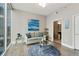 Bright living room with hardwood floors, comfy sofa, and city view at 1080 Peachtree Ne St # 1402, Atlanta, GA 30309