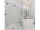 Spa-like bathroom with soaking tub, walk-in shower, and marble tile at 115 N Devereux Nw Ct, Atlanta, GA 30327