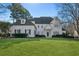 Stunning two-story white brick home with a manicured lawn at 115 N Devereux Nw Ct, Atlanta, GA 30327