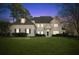 Elegant two-story home with a white brick facade and manicured lawn at 115 N Devereux Nw Ct, Atlanta, GA 30327