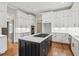 Modern kitchen with white cabinets, quartz countertops, and a large island at 115 N Devereux Nw Ct, Atlanta, GA 30327