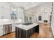 Open concept kitchen with island, gas cooktop and view into living room at 115 N Devereux Nw Ct, Atlanta, GA 30327