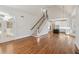 Open living space with hardwood floors, staircase, and kitchen view at 115 N Devereux Nw Ct, Atlanta, GA 30327