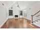 Spacious living room with hardwood floors, built-in shelving, and a fireplace at 115 N Devereux Nw Ct, Atlanta, GA 30327