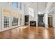 Two-story living room with hardwood floors, fireplace, and built-in shelving at 115 N Devereux Nw Ct, Atlanta, GA 30327