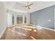 Bright main bedroom with hardwood floors and a wall of windows at 115 N Devereux Nw Ct, Atlanta, GA 30327