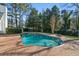 Stunning kidney-shaped pool surrounded by brick at 115 N Devereux Nw Ct, Atlanta, GA 30327