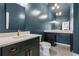 Stylish powder room with dark vanity and marble flooring at 115 N Devereux Nw Ct, Atlanta, GA 30327