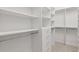 Bright walk-in closet with custom built-in shelving and drawers at 115 N Devereux Nw Ct, Atlanta, GA 30327