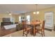 Bright dining area with wood table and chairs, adjacent to living room at 1491 Saint George Pl, Conyers, GA 30012