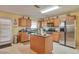 Kitchen with island, stainless steel appliances, and wood cabinets at 1491 Saint George Pl, Conyers, GA 30012