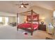 Main bedroom features high ceilings, a four-poster bed, and ample space at 1491 Saint George Pl, Conyers, GA 30012