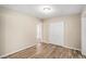 Simple bedroom with wood-look tile flooring and double doors leading to a closet at 2681 Plantation Dr, Atlanta, GA 30344