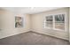 Spacious bedroom with neutral walls and carpet flooring, featuring two large windows at 2681 Plantation Dr, Atlanta, GA 30344