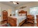 Bedroom with wooden bed frame, ceiling fan, and access to bath at 2972 Lookout Ne Pl, Atlanta, GA 30305