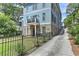 Three-story home with stone and blue siding, a driveway, and a landscaped front yard at 2972 Lookout Ne Pl, Atlanta, GA 30305