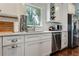 White kitchen with stainless steel appliances and hardwood floors at 2972 Lookout Ne Pl, Atlanta, GA 30305