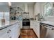 Modern white kitchen with stainless steel appliances and hardwood floors at 2972 Lookout Ne Pl, Atlanta, GA 30305