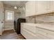 Bright laundry room, farmhouse sink, white cabinets, and modern washer at 2972 Lookout Ne Pl, Atlanta, GA 30305