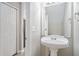 Small bathroom with pedestal sink and a mirror at 3530 Kingsbrooke Ct, Decatur, GA 30034