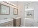 Main bathroom with double vanity and shower/tub combo at 3530 Kingsbrooke Ct, Decatur, GA 30034