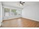 Spacious bedroom featuring wood-look floors and multiple windows at 5879 Wellborn Trl, Lithonia, GA 30058