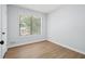 Spacious bedroom with large window and wood-look flooring at 5879 Wellborn Trl, Lithonia, GA 30058