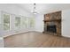 Living room features a stone fireplace and wood-look flooring at 5879 Wellborn Trl, Lithonia, GA 30058