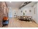 Industrial-style dining area with wood table and exposed brick wall at 800 Peachtree Ne St # 8429, Atlanta, GA 30308