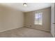 Simple bedroom with neutral walls and carpet, featuring a window at 912 Northridge Nw Dr, Conyers, GA 30012